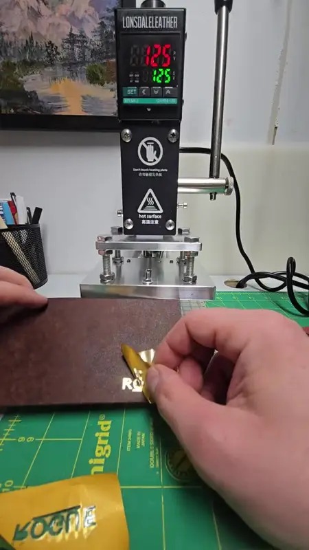 Gold stamp, fresh off the press — Rogue Artisan leather workshop, East Vancouver