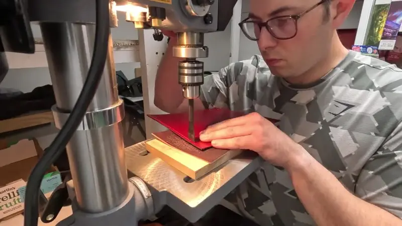 Pressing into red leather — Rogue Artisan leather workshop, East Vancouver