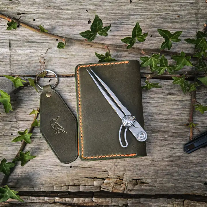 Olive notebook cover with a raven-stamped key fob — Rogue Artisan, East Vancouver