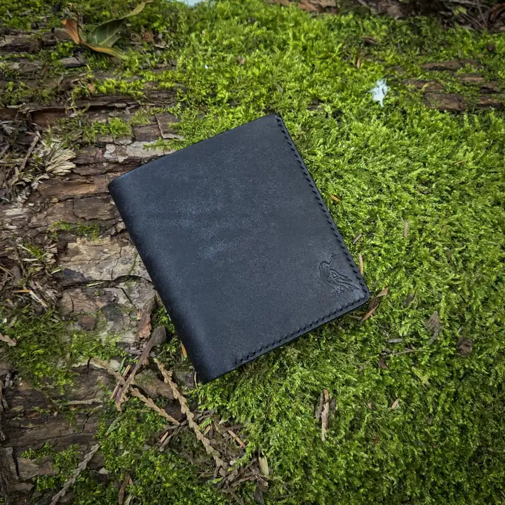Black bifold on a mossy log — Rogue Artisan, East Vancouver