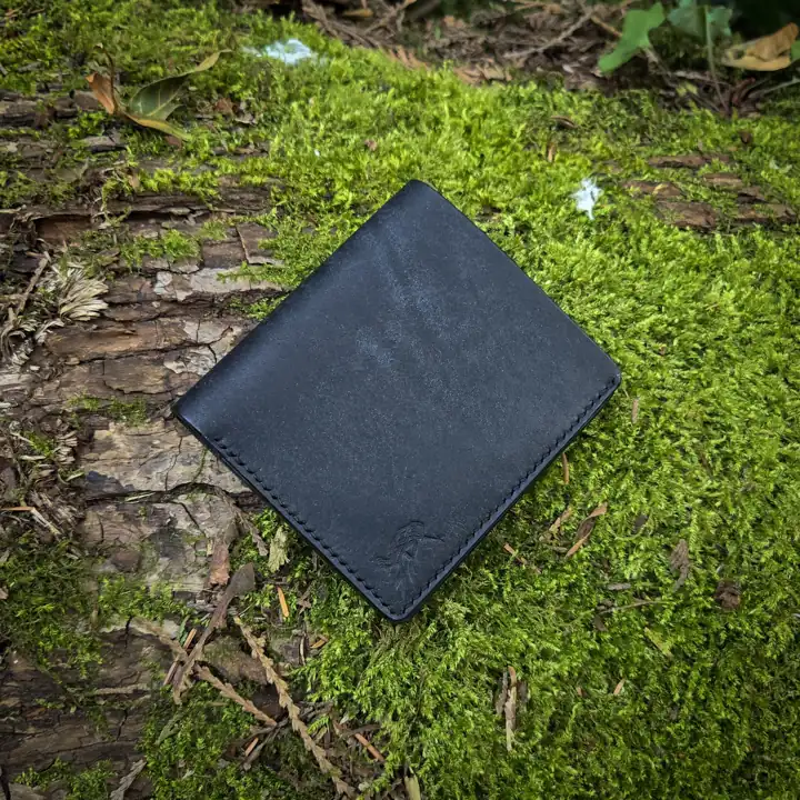 Black card wallet on the moss — Rogue Artisan, East Vancouver