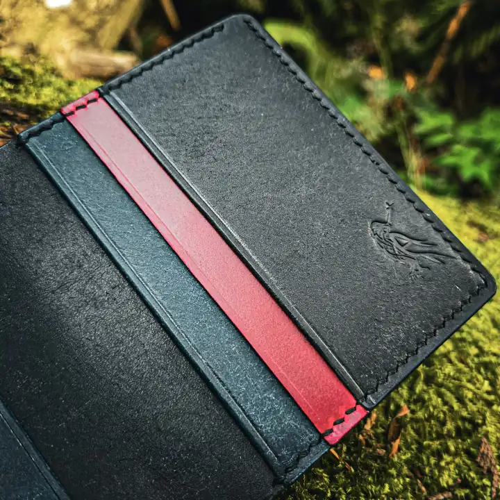 Raven mark on a colour-lined card holder, up close — Rogue Artisan, East Vancouver