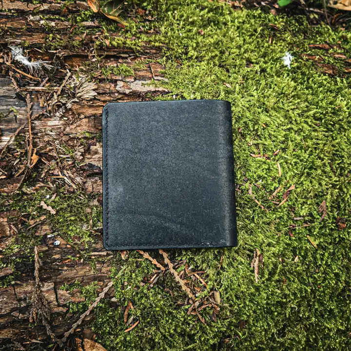 Minimal black wallet on the forest floor — Rogue Artisan, East Vancouver